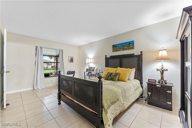 bedroom with baseboards and light tile patterned floors