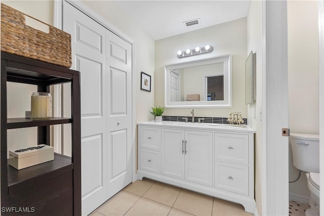 bathroom with vanity, tile patterned flooring, toilet, and visible vents