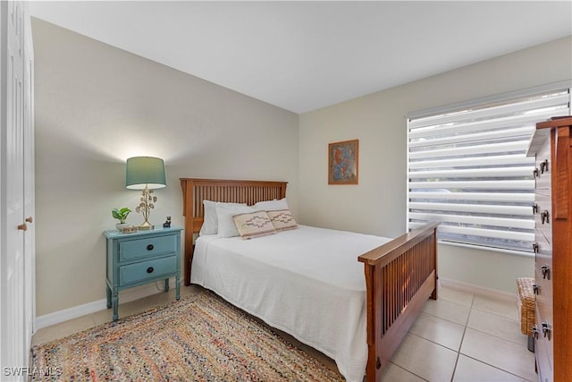 bedroom featuring baseboards and light tile patterned floors
