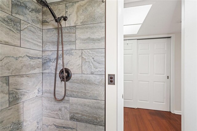 6451 Scott Ln, Fort Myers, FL 33966 - full bathroom featuring a tile shower and wood finished floors