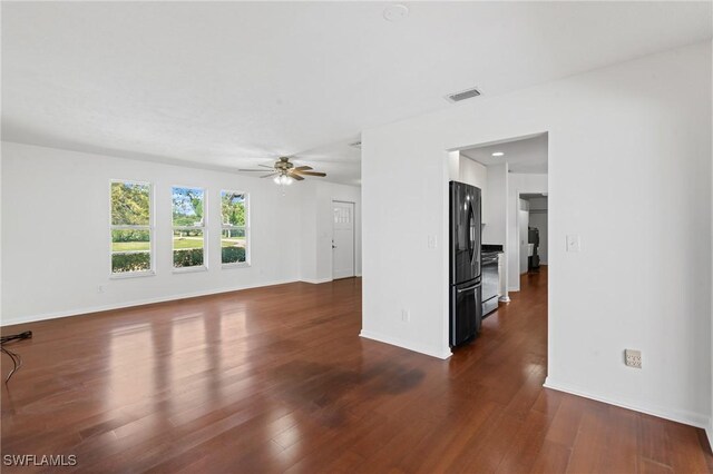 6451 Scott Ln, Fort Myers, FL 33966 - unfurnished living room featuring dark wood-style floors, ceiling fan, visible vents, and baseboards
