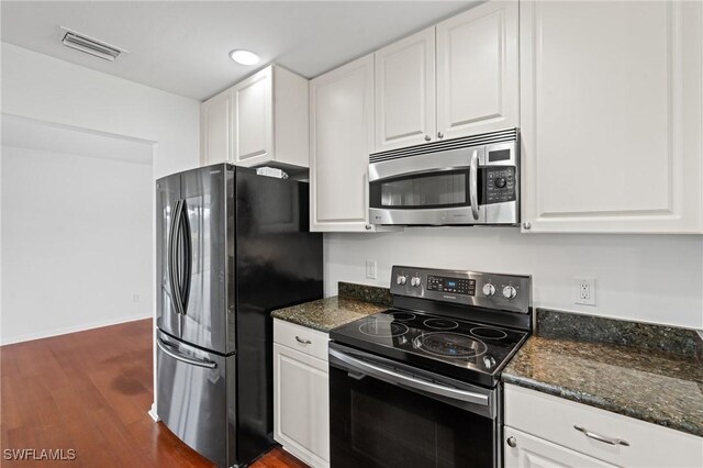 6451 Scott Ln, Fort Myers, FL 33966 - kitchen featuring white cabinetry, visible vents, appliances with stainless steel finishes, and dark wood-style flooring