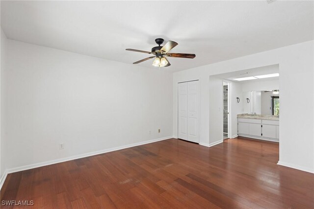 6451 Scott Ln, Fort Myers, FL 33966 - unfurnished bedroom with a closet, dark wood finished floors, connected bathroom, and baseboards