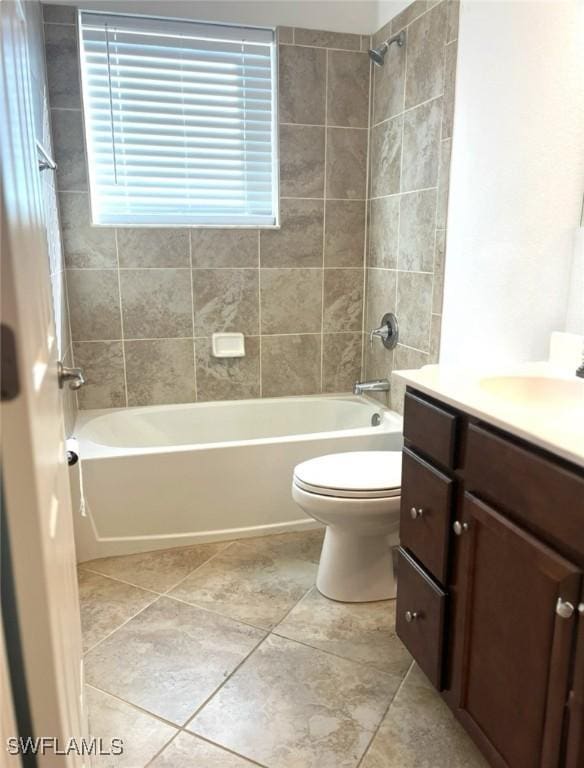 bathroom with toilet, tile patterned floors, vanity, and shower / bathing tub combination