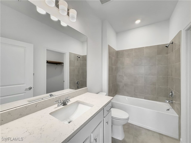 full bath with toilet, shower / bath combination, vanity, tile patterned floors, and a walk in closet