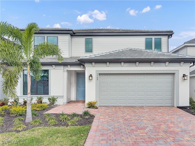 view of front of home featuring decorative driveway and stucco siding