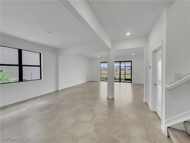 spare room featuring light tile patterned flooring, stairs, baseboards, and recessed lighting