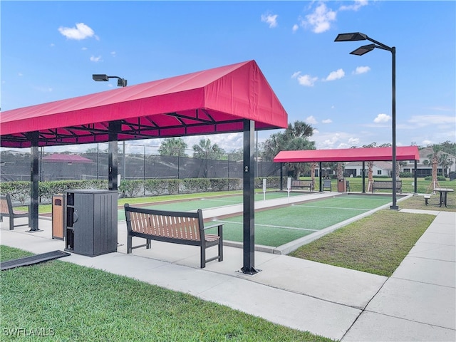 surrounding community with a lawn and fence