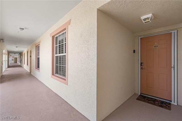 entrance to property with stucco siding