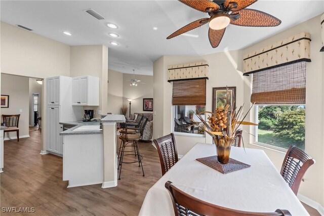 dining room featuring a ceiling fan, recessed lighting, visible vents, and wood finished floors