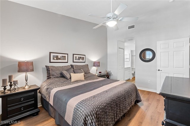 bedroom with light wood finished floors, baseboards, visible vents, connected bathroom, and ceiling fan