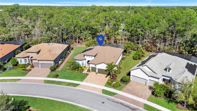 birds eye view of property with a residential view and a view of trees