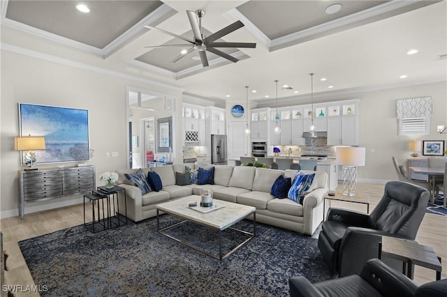 living room featuring light wood-style floors, coffered ceiling, and crown molding