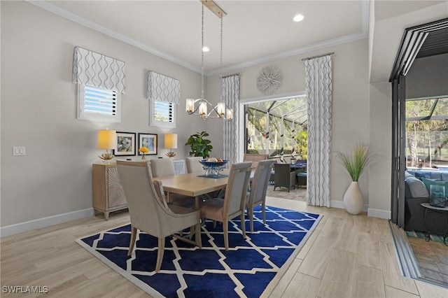 dining space with baseboards, wood finished floors, and crown molding