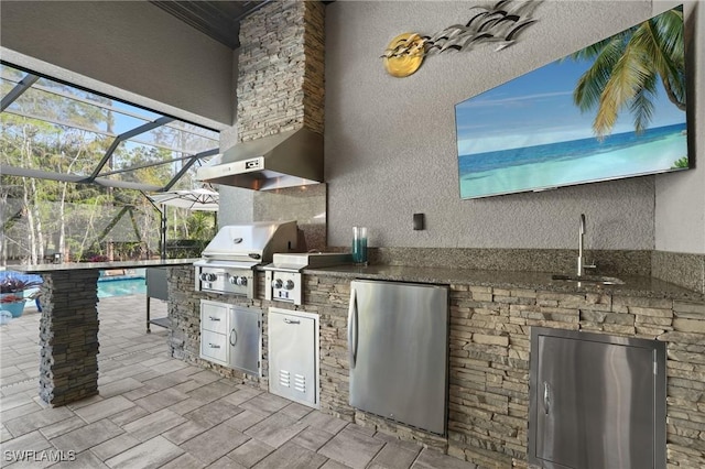 view of patio / terrace with an outdoor kitchen, area for grilling, a sink, a lanai, and an outdoor pool