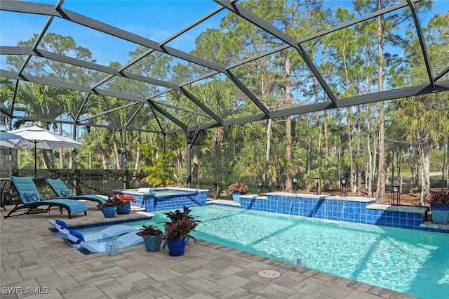 view of pool with glass enclosure, a pool with connected hot tub, and a patio