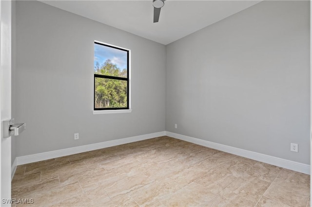 unfurnished room with a ceiling fan and baseboards