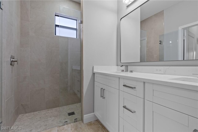 bathroom featuring walk in shower, a sink, and double vanity