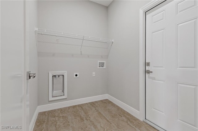 laundry area with baseboards, laundry area, hookup for a washing machine, and hookup for an electric dryer