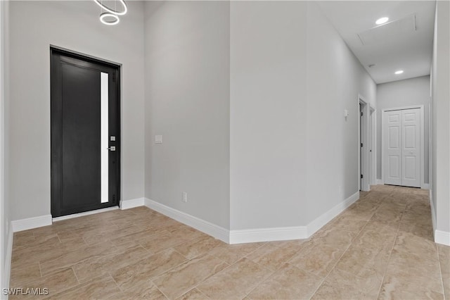 foyer featuring recessed lighting and baseboards