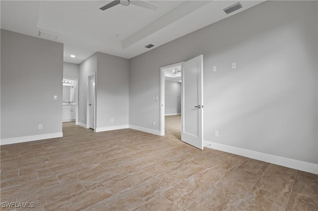 empty room with baseboards, visible vents, and a ceiling fan