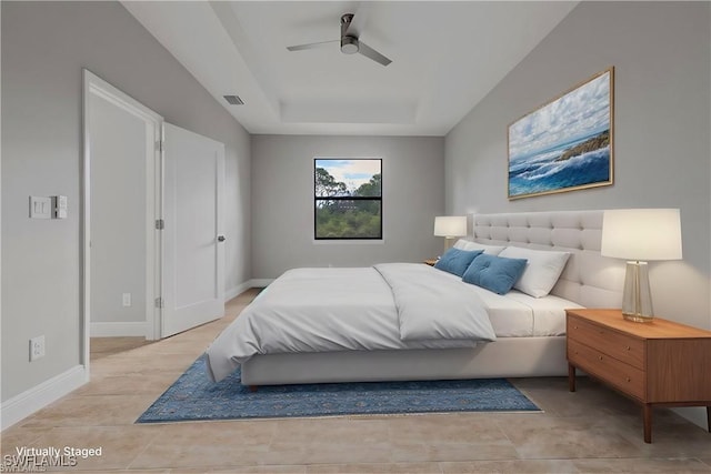 bedroom with light tile patterned floors, a raised ceiling, visible vents, ceiling fan, and baseboards