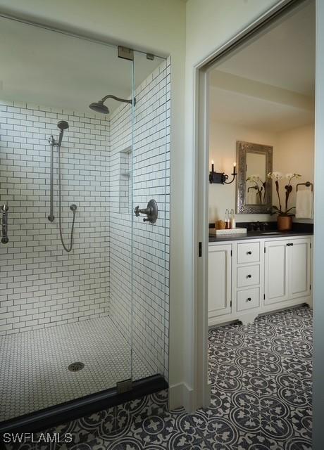 full bath featuring a shower stall, tile patterned flooring, and vanity