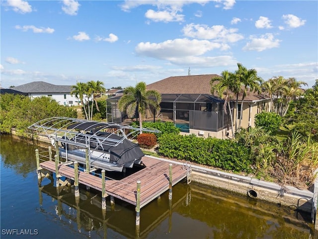 view of dock featuring glass enclosure, a water view, and boat lift