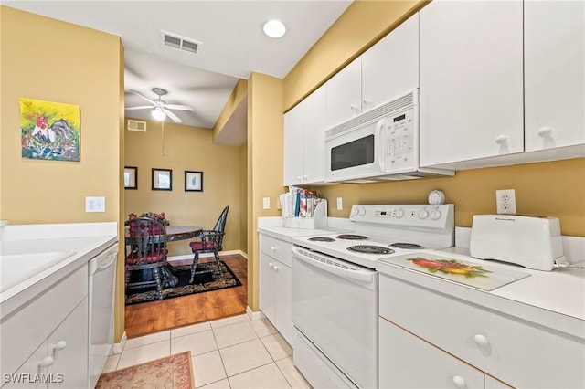 kitchen featuring light countertops, visible vents, white cabinetry, light tile patterned flooring, and white appliances