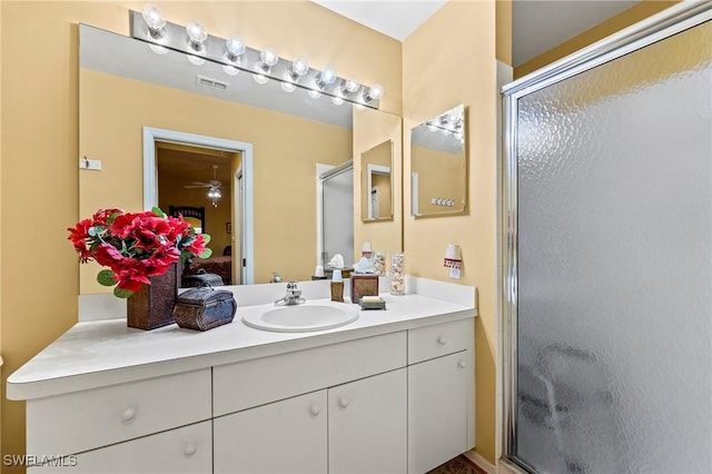 bathroom with a stall shower, visible vents, and vanity