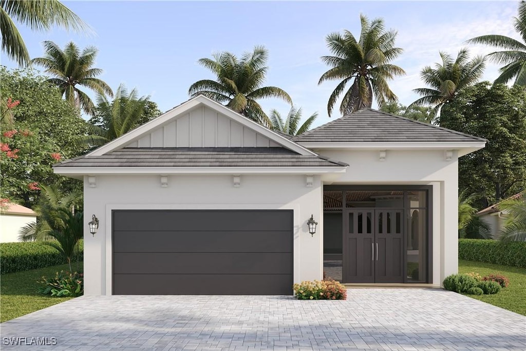 668 93rd Ave N, Naples, FL 34108 - view of front of property featuring decorative driveway, stucco siding, and a garage