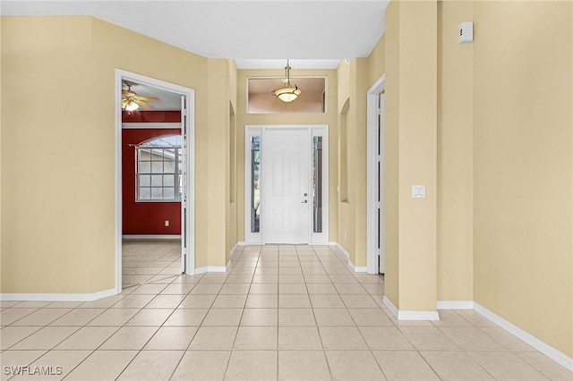 3266 Sturgeon Bay Ct, Naples, FL 34120 - entrance foyer with arched walkways, baseboards, and light tile patterned floors