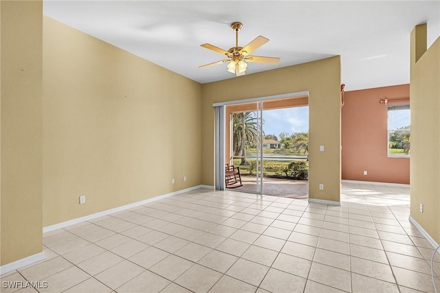 3266 Sturgeon Bay Ct, Naples, FL 34120 - spare room featuring light tile patterned flooring, a ceiling fan, and baseboards