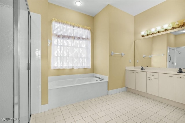 3266 Sturgeon Bay Ct, Naples, FL 34120 - full bathroom with a garden tub, a shower stall, vanity, tile patterned flooring, and baseboards