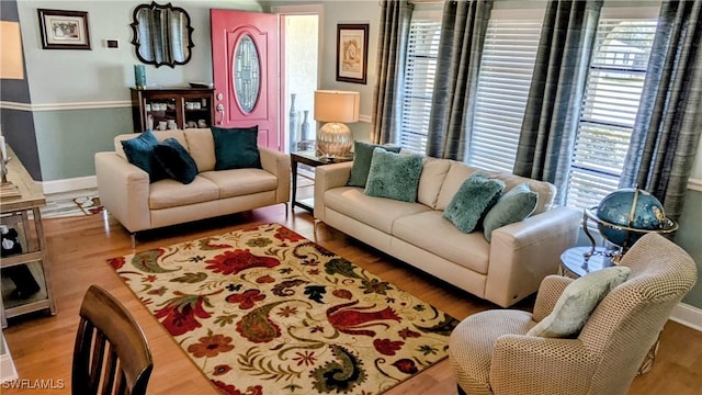 living area featuring baseboards and wood finished floors