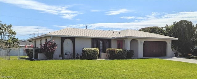 single story home featuring a garage, concrete driveway, stucco siding, metal roof, and a front yard