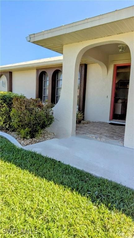 doorway to property with stucco siding