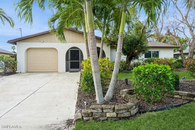 view of front of house featuring concrete driveway, an attached garage, and stucco siding