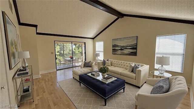 living room featuring vaulted ceiling with beams, a textured ceiling, baseboards, light wood-style floors, and crown molding