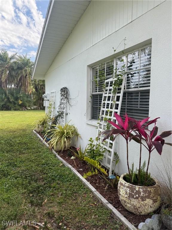 view of home's exterior featuring a yard and stucco siding