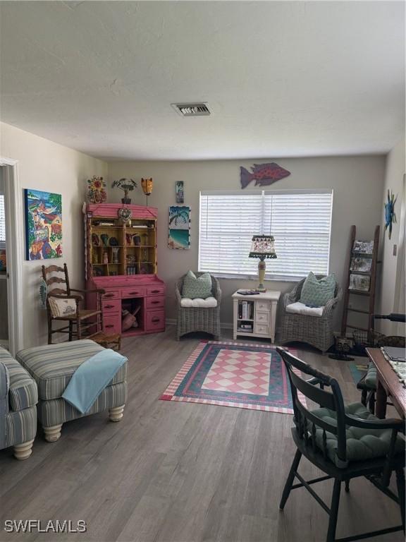 sitting room with visible vents and wood finished floors