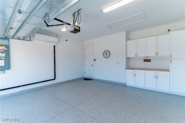 garage featuring baseboards, a wall mounted AC, and a garage door opener