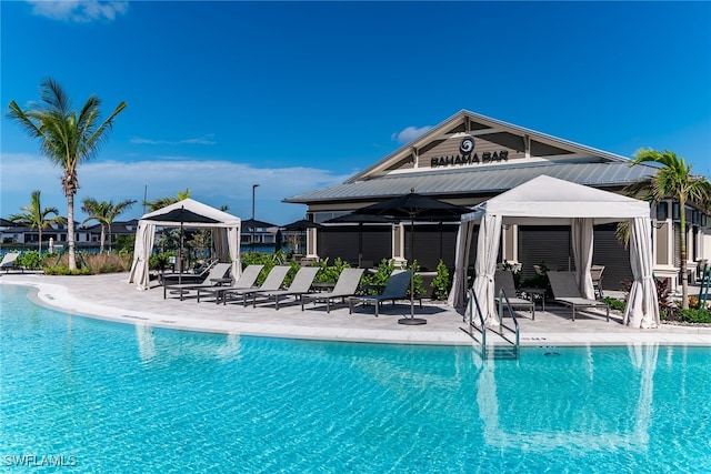 pool featuring a patio and a gazebo