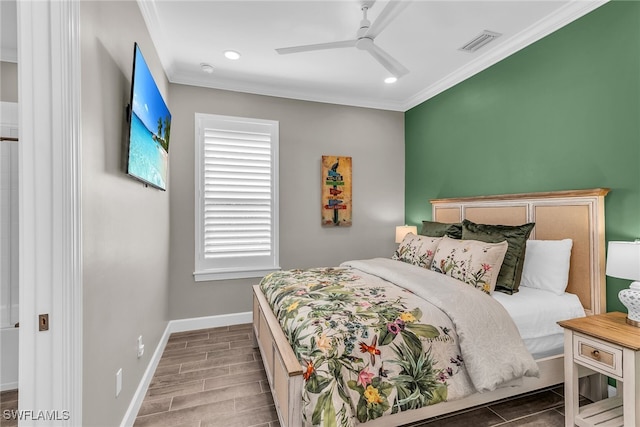 bedroom with crown molding, wood finish floors, visible vents, and baseboards