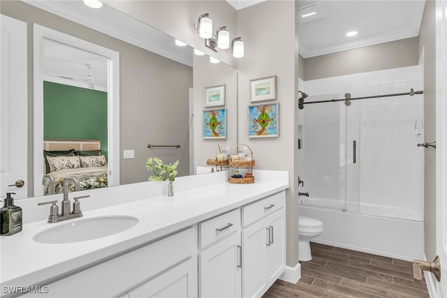 bathroom featuring connected bathroom, toilet, vanity, wood tiled floor, and crown molding