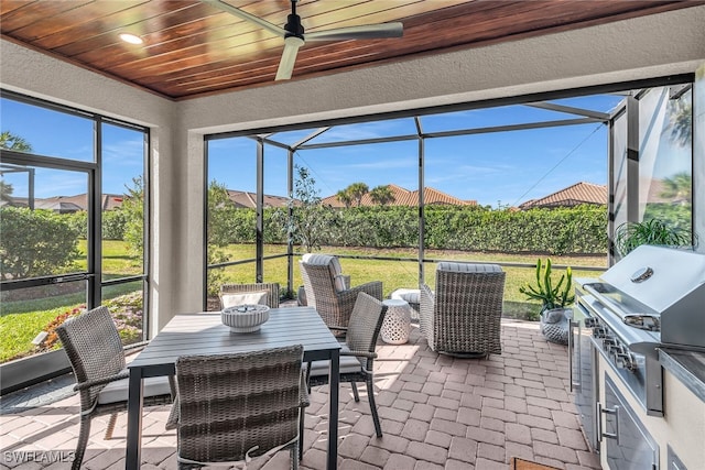 sunroom with wooden ceiling and a ceiling fan