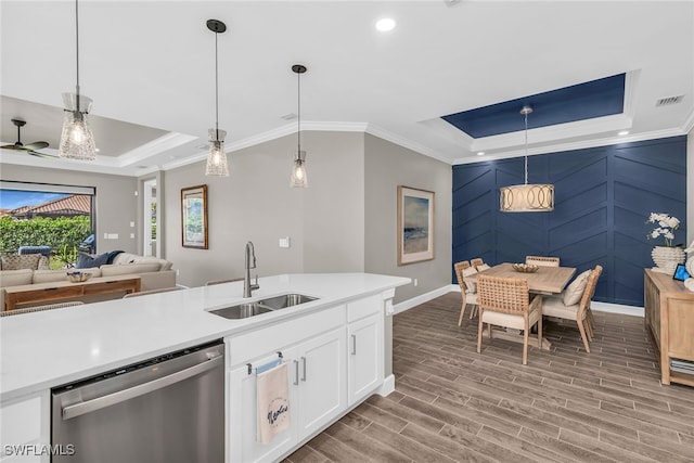 kitchen with visible vents, a raised ceiling, dishwasher, wood tiled floor, and a sink