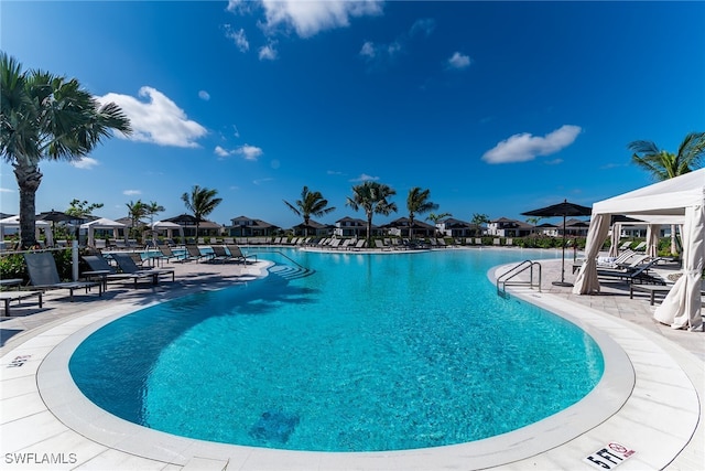 community pool featuring a patio and a residential view