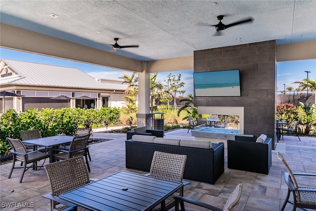 view of patio with a ceiling fan, outdoor dining area, and an outdoor hangout area