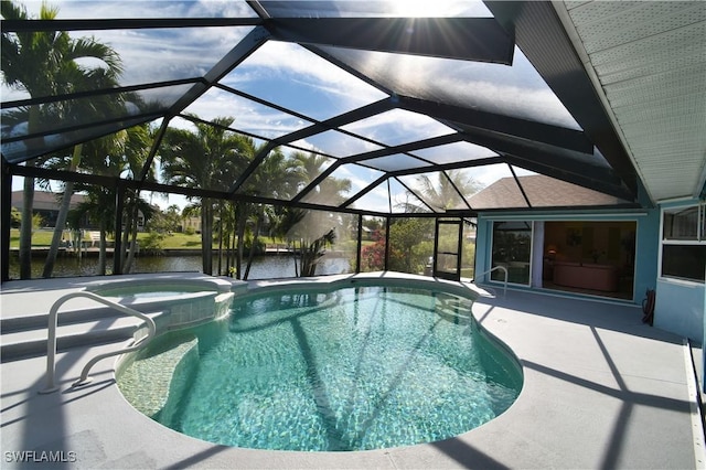 view of swimming pool with a water view, glass enclosure, a pool with connected hot tub, and a patio